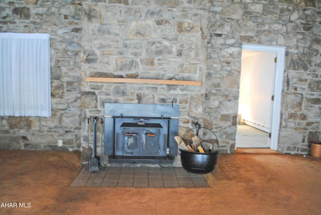 room details with radiator, a wood stove, and carpet floors