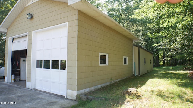 view of side of property featuring a garage and an outdoor structure