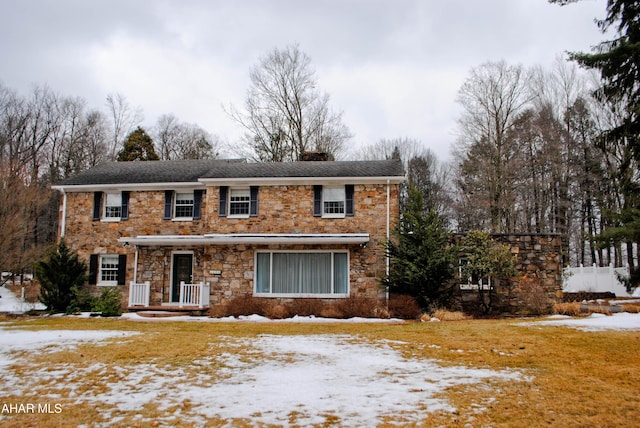 traditional home with stone siding and fence