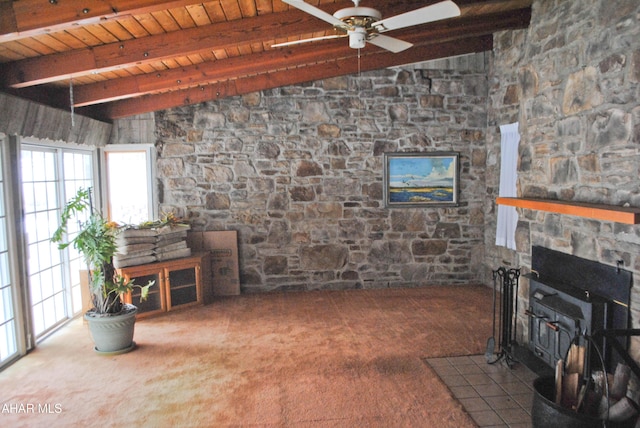 living area with lofted ceiling with beams, a wood stove, wood ceiling, and carpet floors