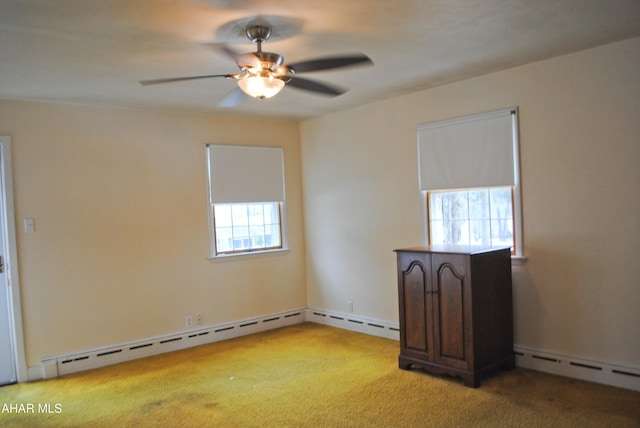 empty room featuring light carpet, a baseboard radiator, and ceiling fan