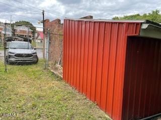 view of gate with a lawn