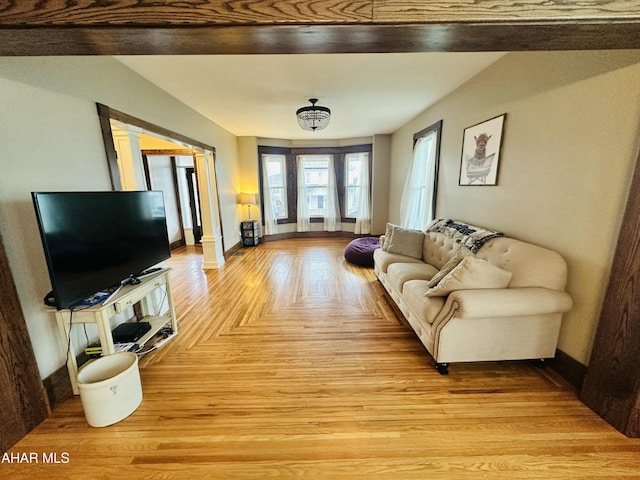 living room featuring light parquet floors and ornate columns