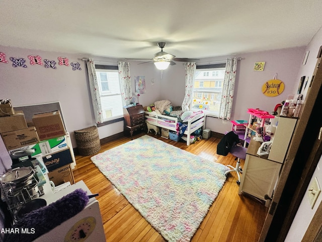 bedroom with wood-type flooring and ceiling fan