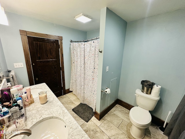 bathroom with vanity, walk in shower, and toilet