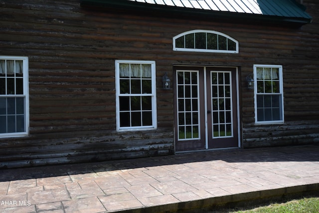 entrance to property featuring a patio area and french doors