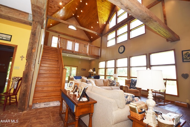 living room featuring beamed ceiling, high vaulted ceiling, and a wealth of natural light