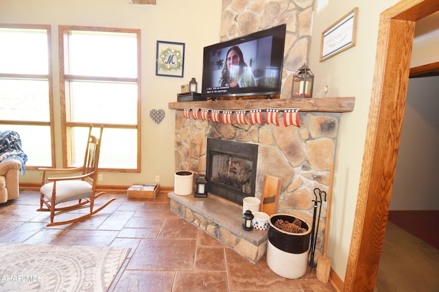 living room with a stone fireplace