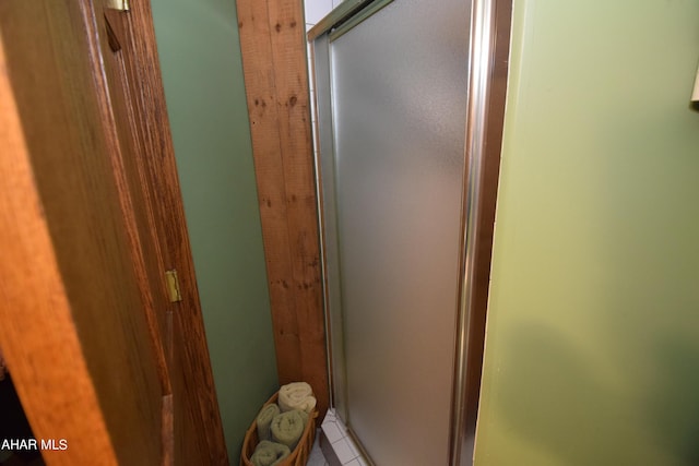 bathroom featuring tile patterned flooring and a shower with shower door