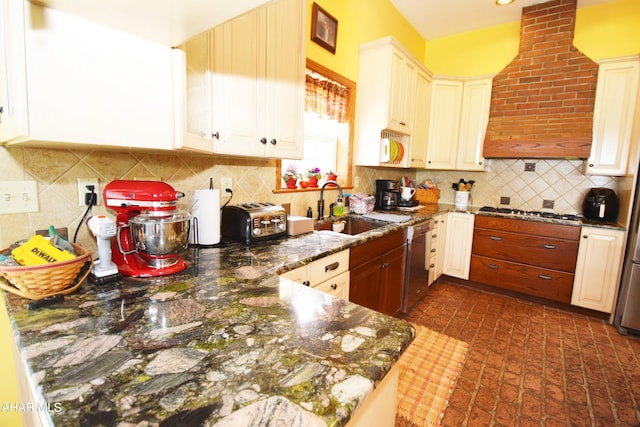 kitchen with backsplash, white cabinets, sink, dark stone countertops, and appliances with stainless steel finishes