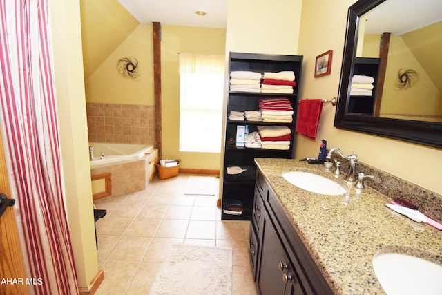 bathroom with tile patterned floors, tiled bath, and vanity