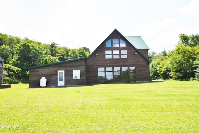 rear view of house with a lawn