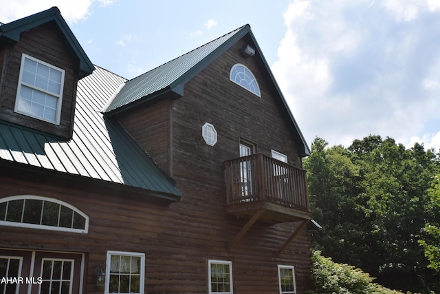 view of side of home with a balcony