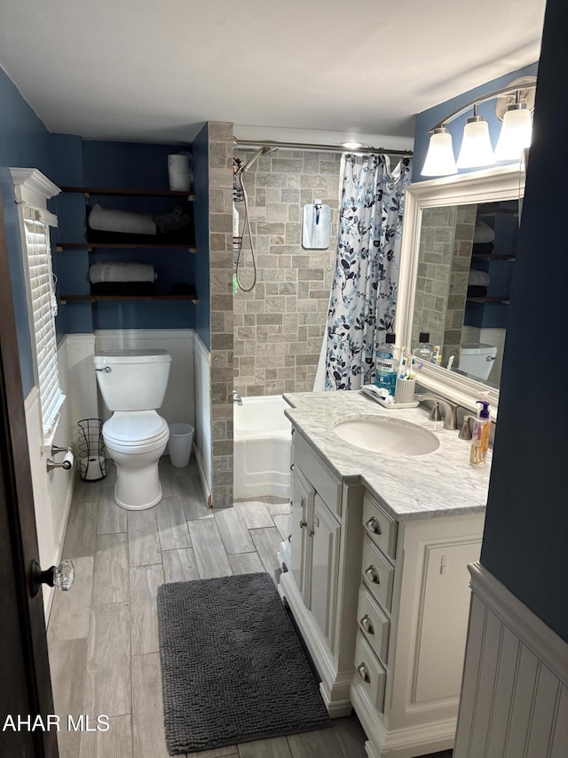 full bathroom with shower / tub combo with curtain, vanity, and toilet