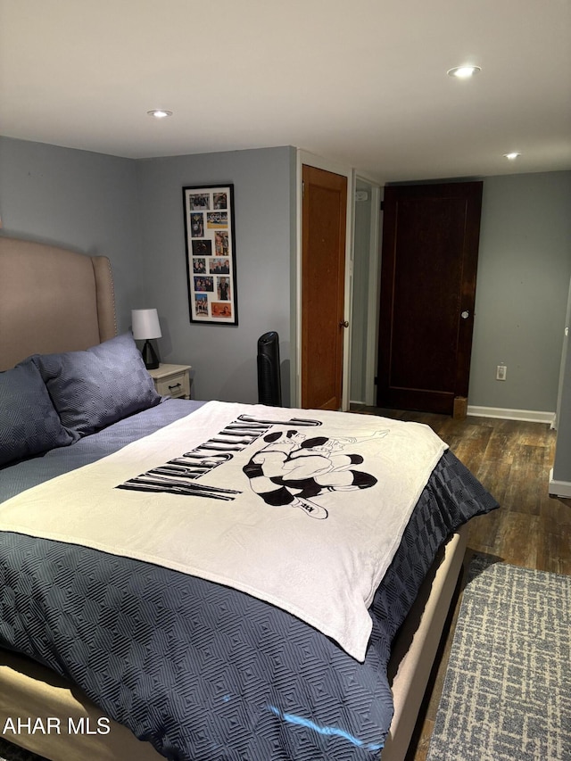 bedroom with dark wood-type flooring