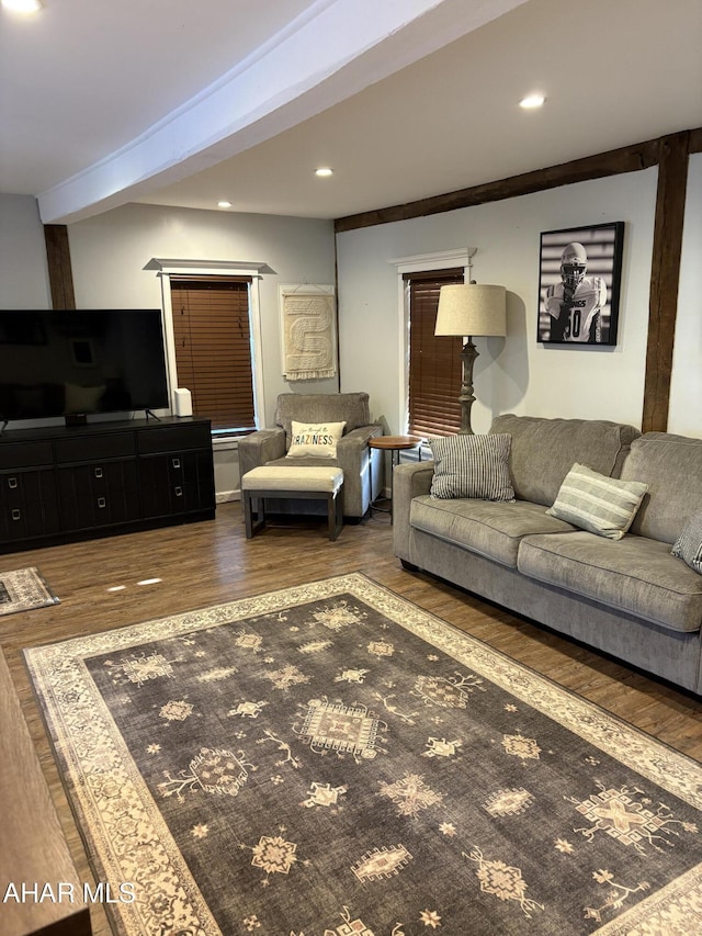 living room with beamed ceiling and dark hardwood / wood-style flooring