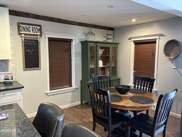 dining area with dark hardwood / wood-style flooring