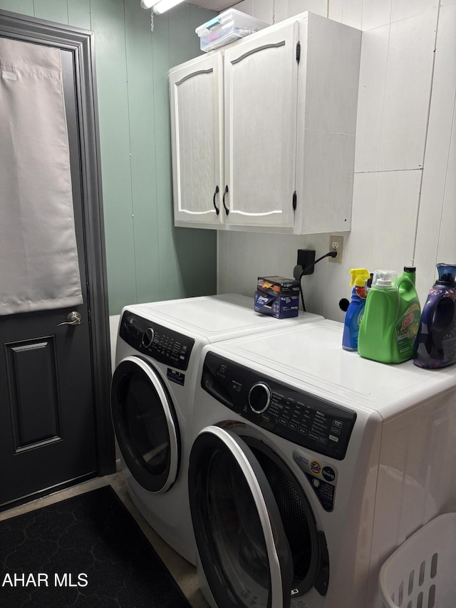 laundry room with independent washer and dryer and cabinets