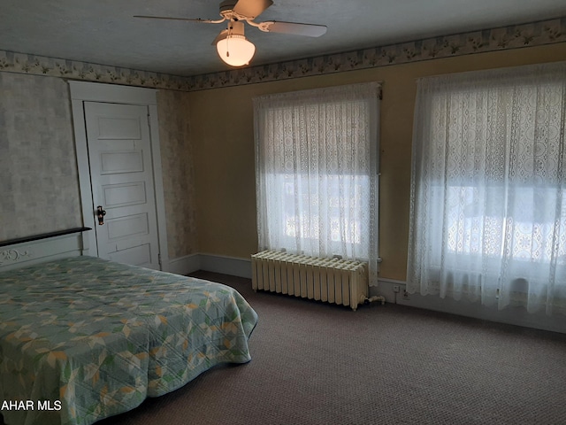 bedroom featuring ceiling fan, carpet floors, and radiator