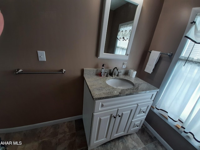 bathroom with vanity and baseboards