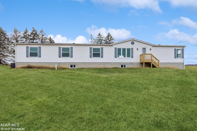 back of house featuring a lawn and central air condition unit