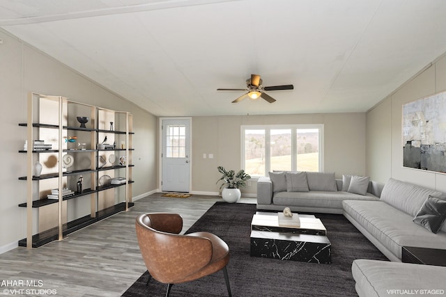 living room with lofted ceiling, ceiling fan, and wood-type flooring