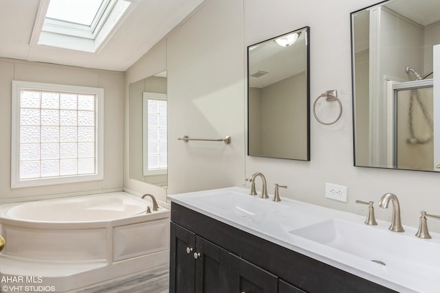 bathroom with hardwood / wood-style flooring, vanity, lofted ceiling with skylight, and plus walk in shower