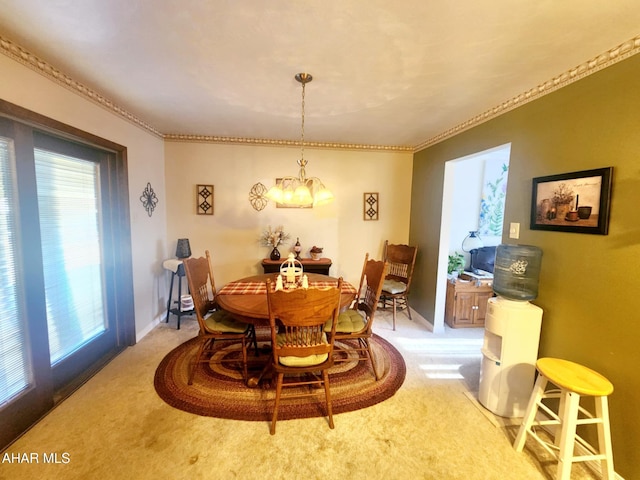 dining area featuring baseboards, light colored carpet, a chandelier, and crown molding