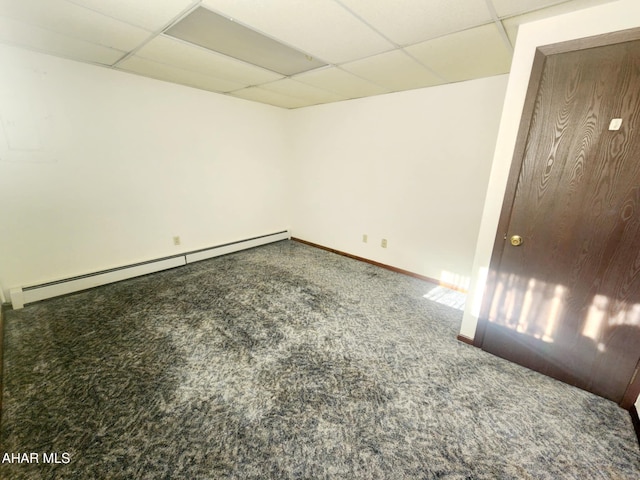 carpeted empty room with a drop ceiling, baseboards, and baseboard heating