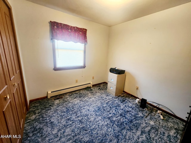 unfurnished bedroom with a baseboard heating unit, baseboards, and carpet floors