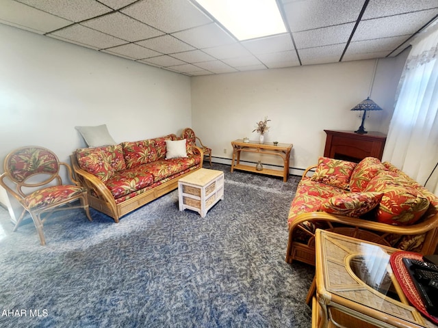 carpeted living room with a drop ceiling and a baseboard heating unit