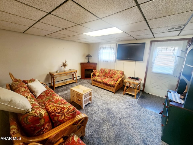 carpeted living area featuring a drop ceiling, visible vents, and baseboard heating