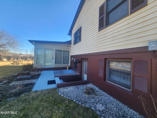 view of side of home featuring a lawn