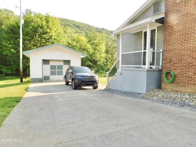 3004 Homers Gap Rd, Altoona, PA 16601 - view of property exterior with driveway, an outbuilding, a garage, a view of trees, and brick siding