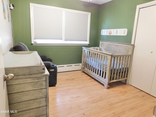 3004 Homers Gap Rd, Altoona, PA 16601 - bedroom with a baseboard heating unit, wood finished floors, and a crib