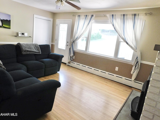 3004 Homers Gap Rd, Altoona, PA 16601 - living room with baseboard heating, ceiling fan, and wood finished floors