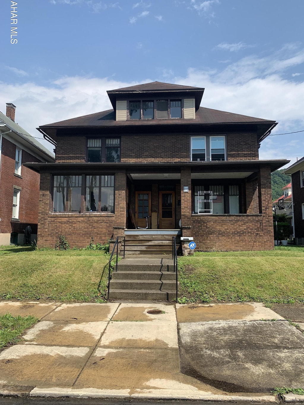 512 Cypress Ave, Johnstown, PA 15902 - view of front of home with a front yard, brick siding, and covered porch