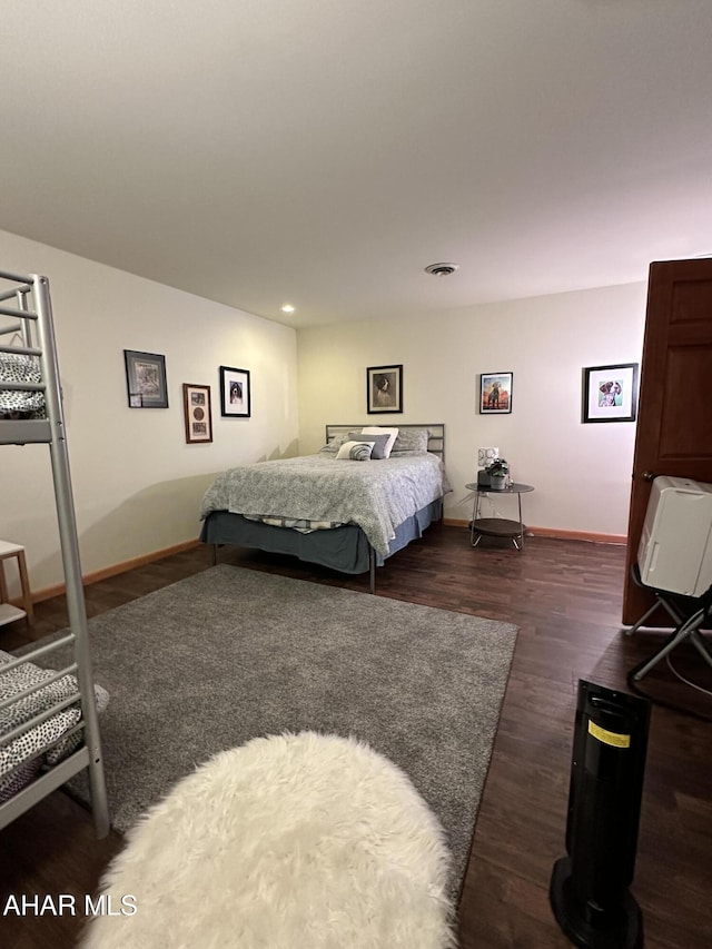 bedroom with dark hardwood / wood-style floors