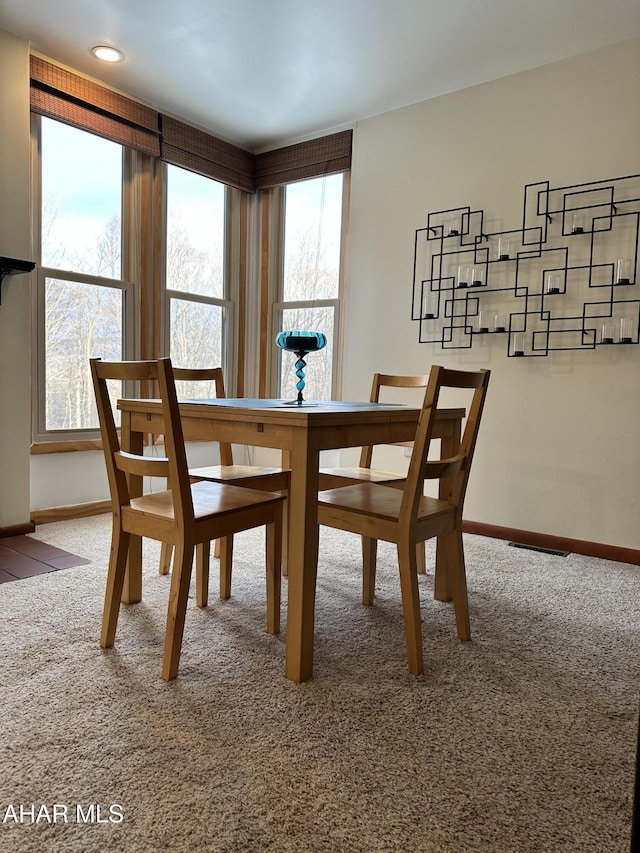 dining area with carpet floors and a healthy amount of sunlight