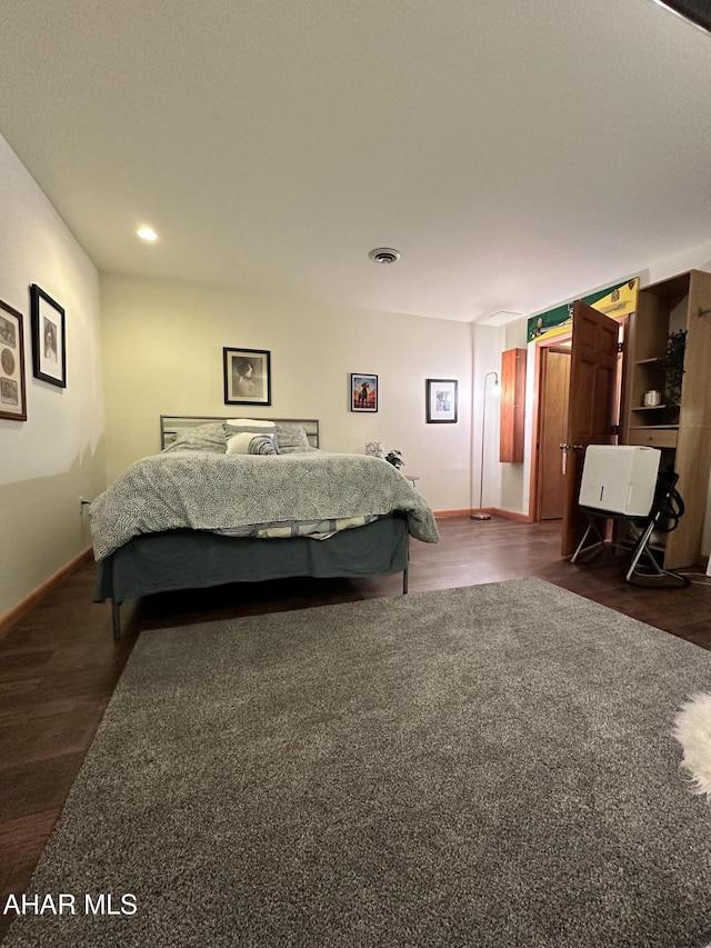 bedroom featuring dark hardwood / wood-style flooring