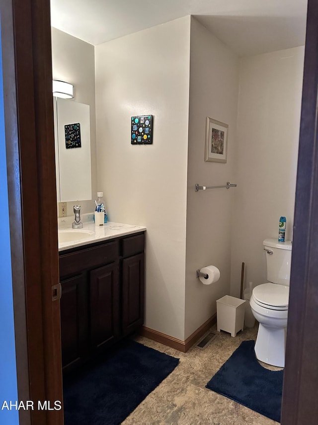 bathroom with vanity and toilet