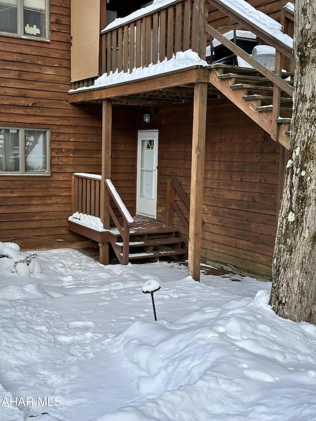 view of snow covered property entrance