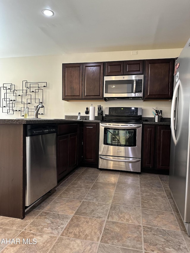 kitchen featuring stainless steel appliances and dark brown cabinetry