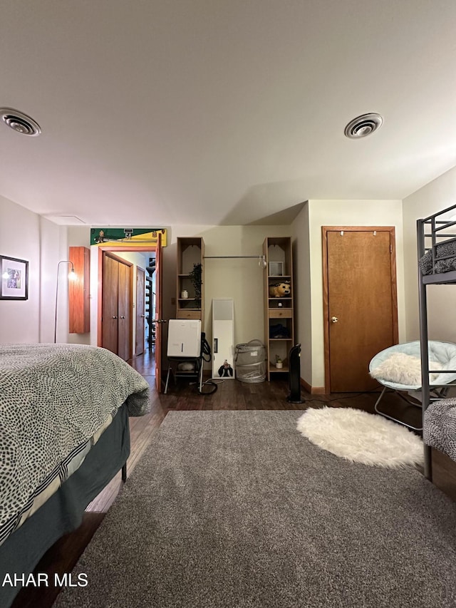 bedroom with dark wood-type flooring