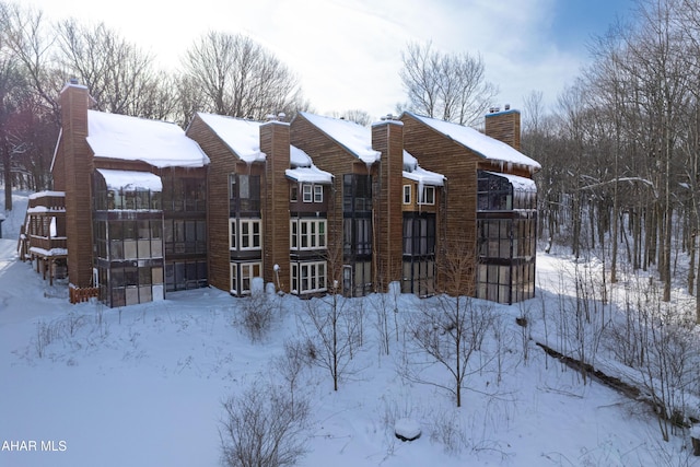 view of snow covered back of property