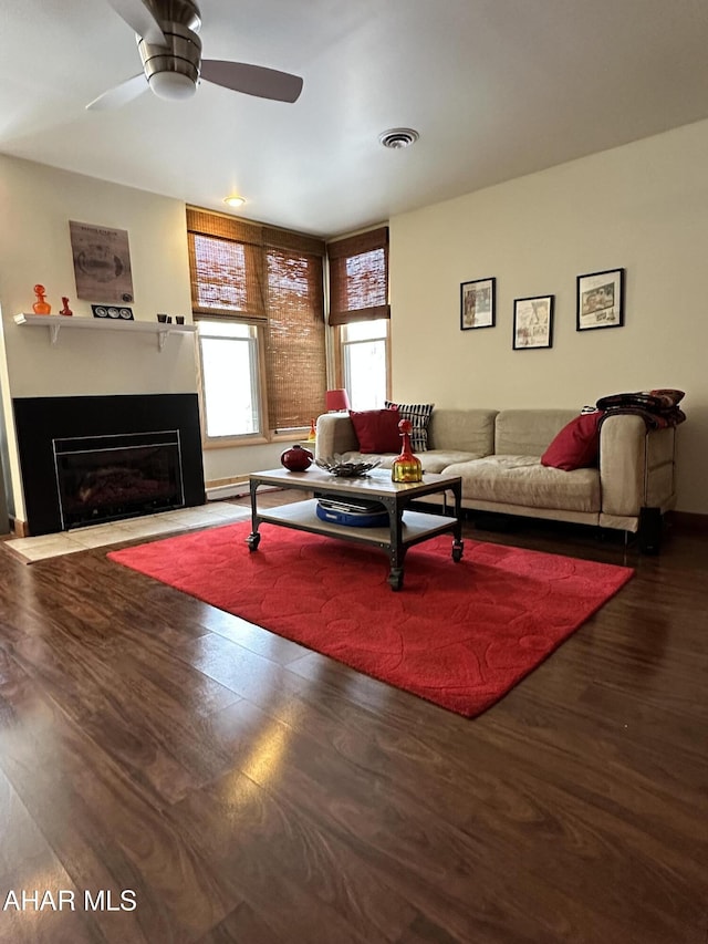 living room with wood-type flooring and ceiling fan