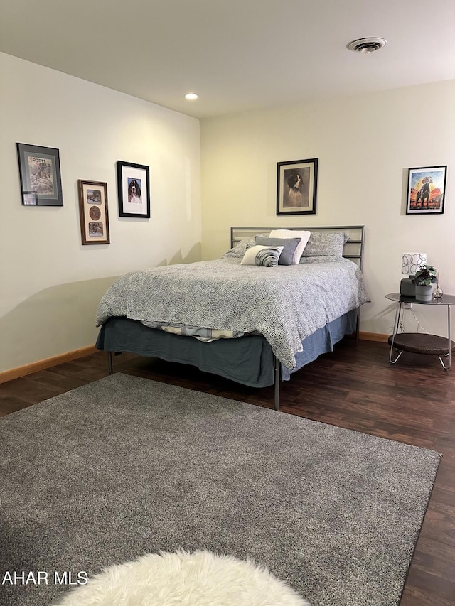 bedroom with dark wood-type flooring