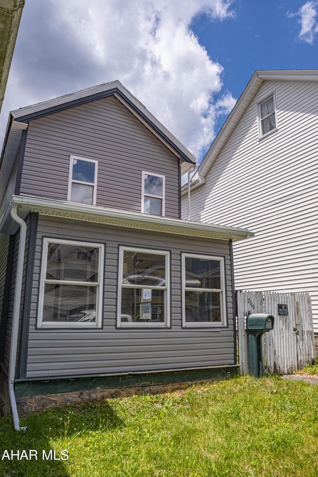 back of house with a yard