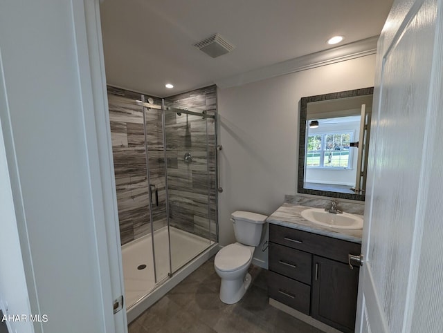 bathroom featuring vanity, crown molding, a shower with shower door, and toilet