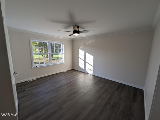 empty room featuring crown molding, dark wood-type flooring, and ceiling fan